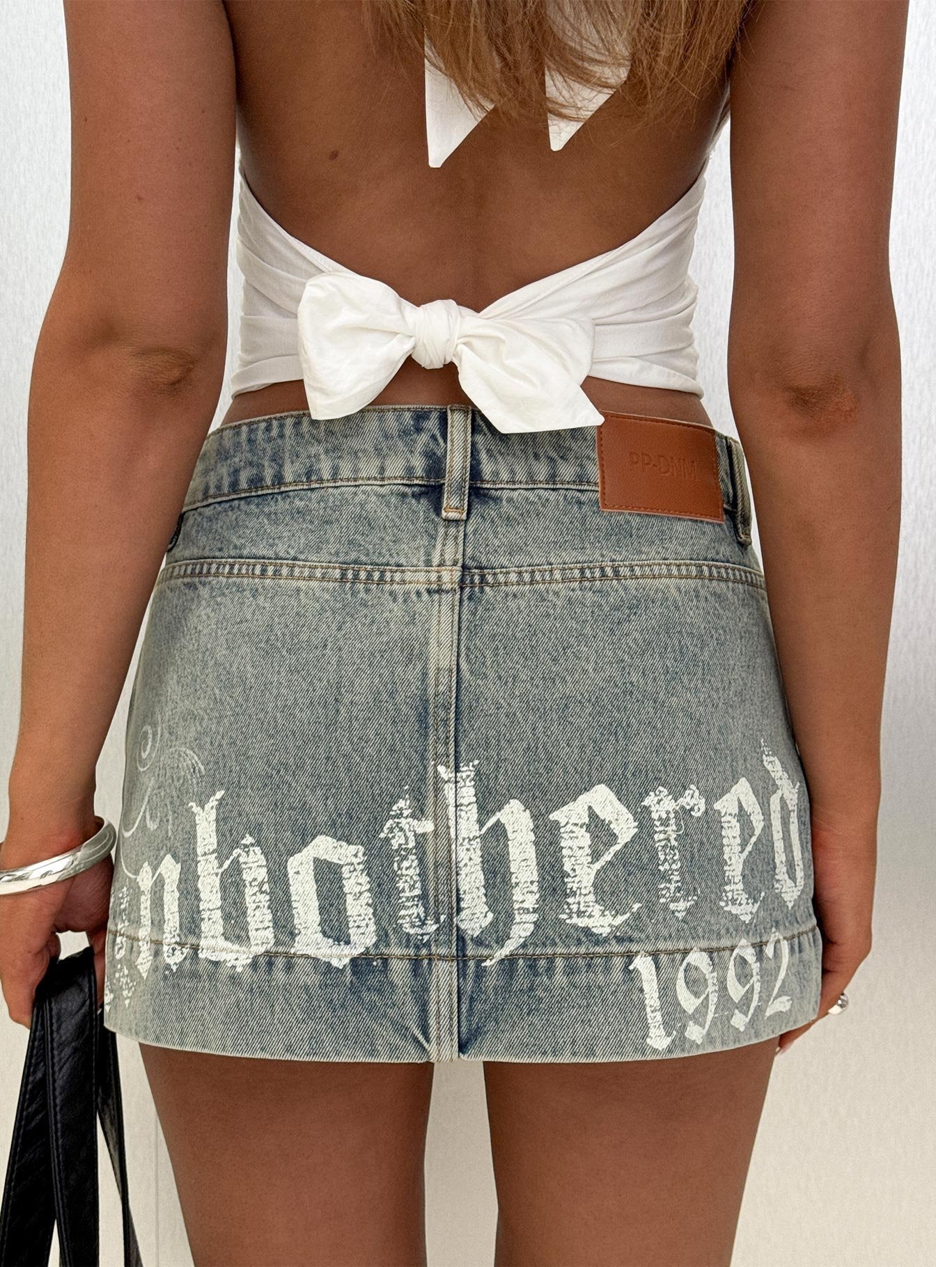   front view of model wearing Princess Polly Arigatou Graphic Denim Mini Skirt Light Blue Mini Skirts Skirts 