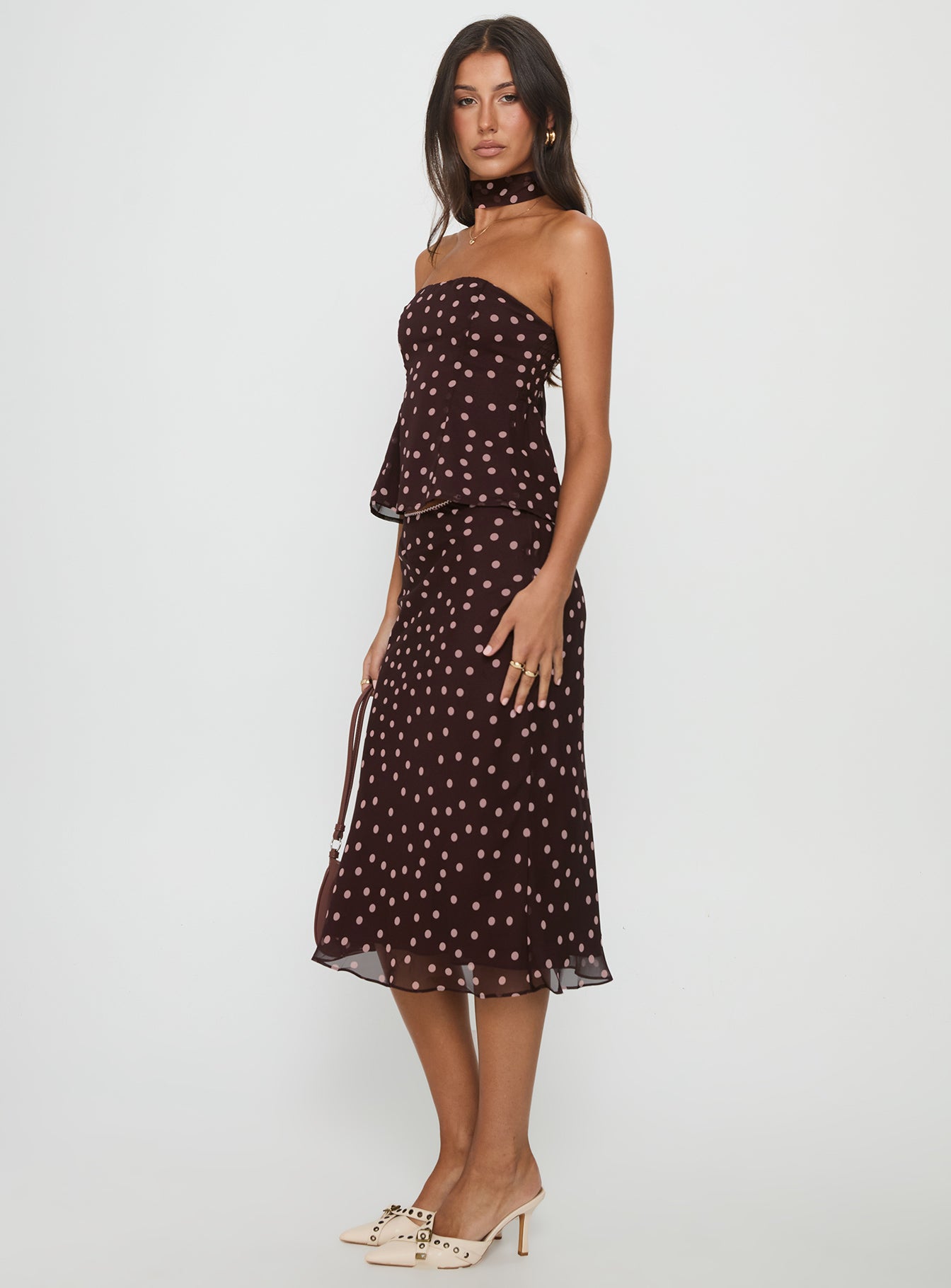   side view of model wearing Princess Polly Sydni Midi Bias Cut Skirt Chocolate / Pink Polka Midi Skirts 