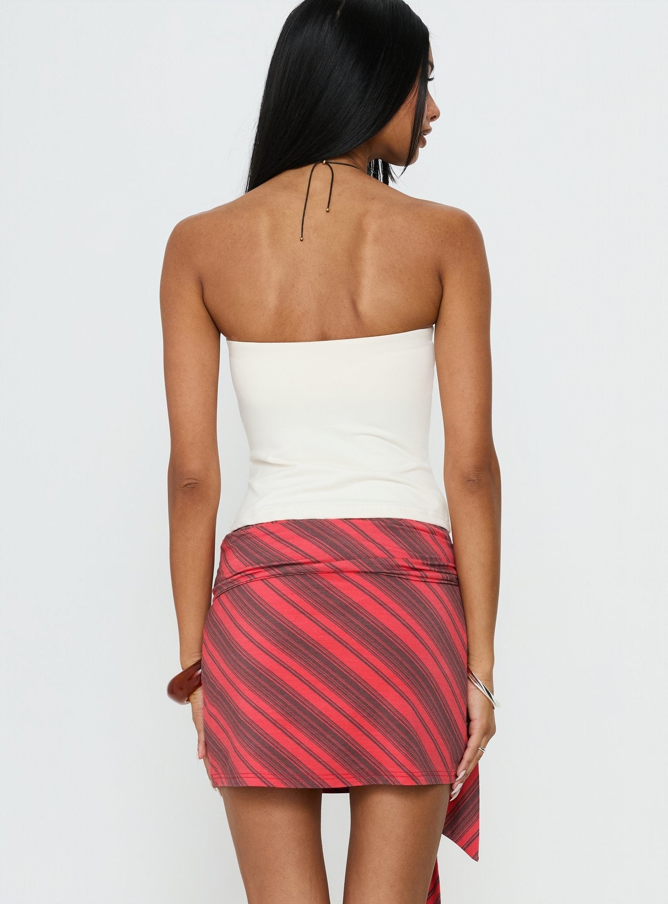 back view of model wearing Princess Polly Lindsy Tie Side Mini Skirt Red Multi Mini Skirts 