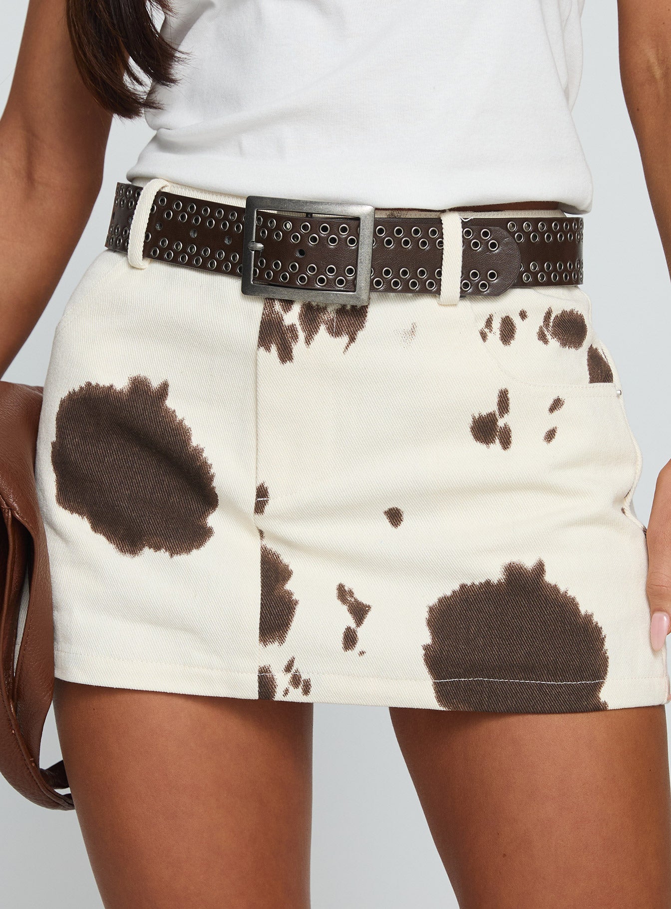 back view of model wearing Princess Polly Maxa Denim Mini Skirt Cow Print Mini Skirts 