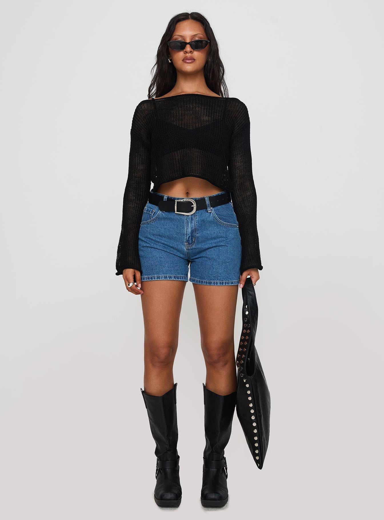 side view of model wearing Princess Polly Saldana Shorts Mid Blue Denim High Waisted Shorts 